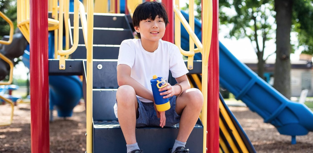 Kids water Bottle a boy holding a water bottle and sitting on stairs