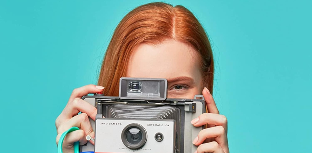 a girl holding One best kids water bottle with camera