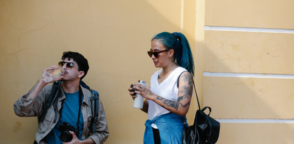 a boy and a girl holding reusable water bottles